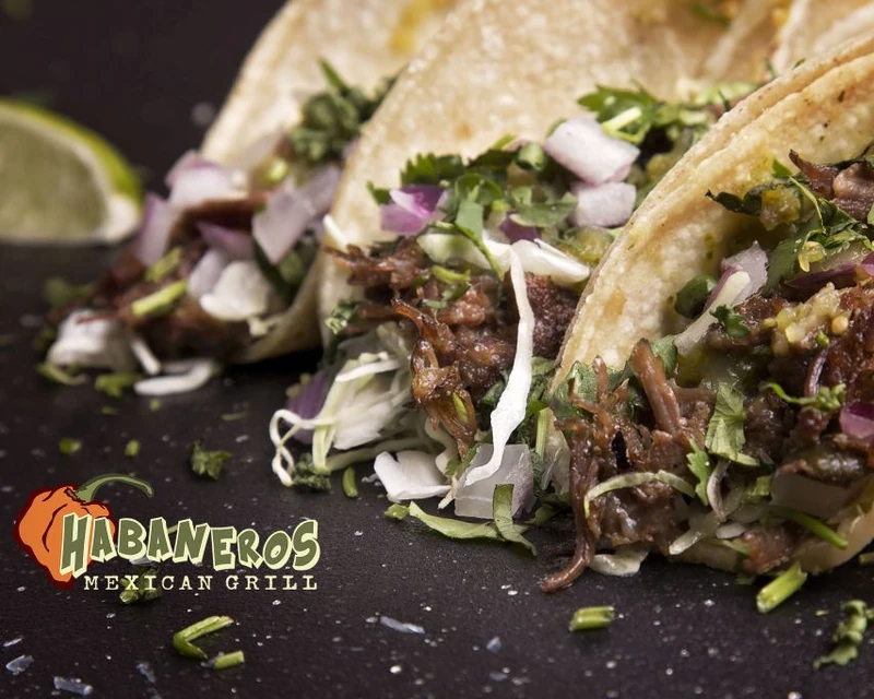 Carne asada tacos in Leduc, AB - three corn tortilla tacos with rice and refried beans at Habaneros Mexican Grill